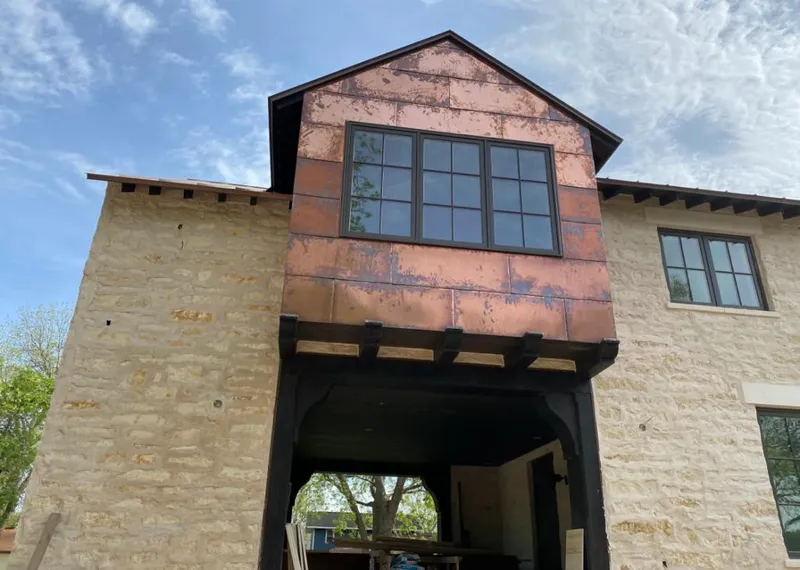 Copper metal panel facade on a stone building for Roof Repair in Clarkston