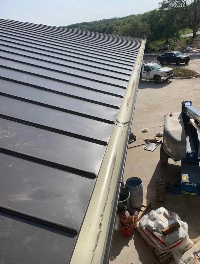 Standing seam panel and gutter detail on a metal roofing jobsite in Clarkston